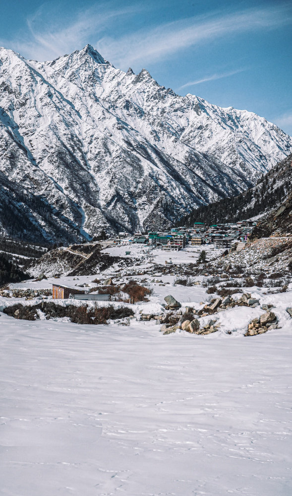 Snow-covered mountains with a scenic village nestled in the valley